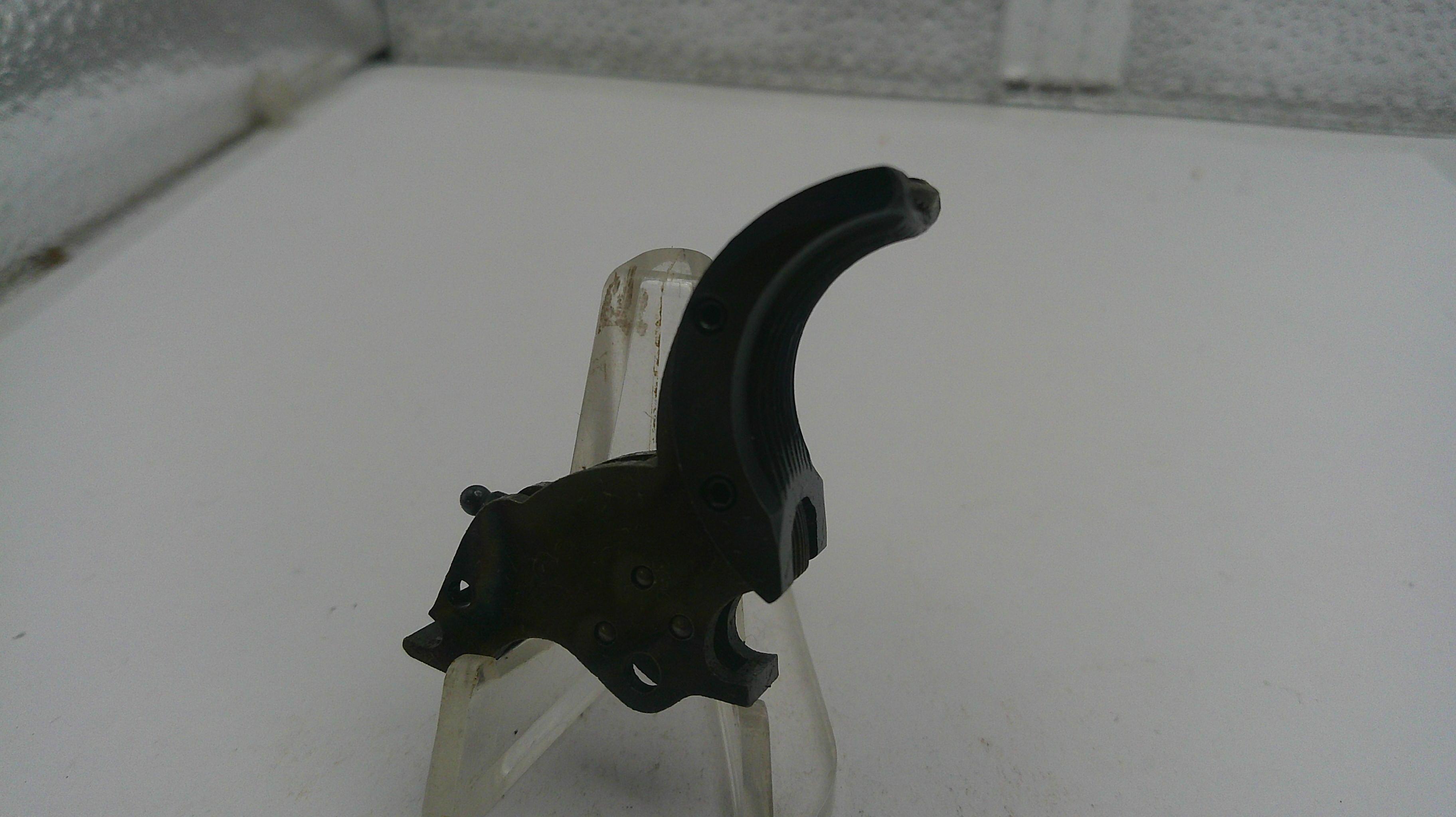 Black archery bow nock on a white surface