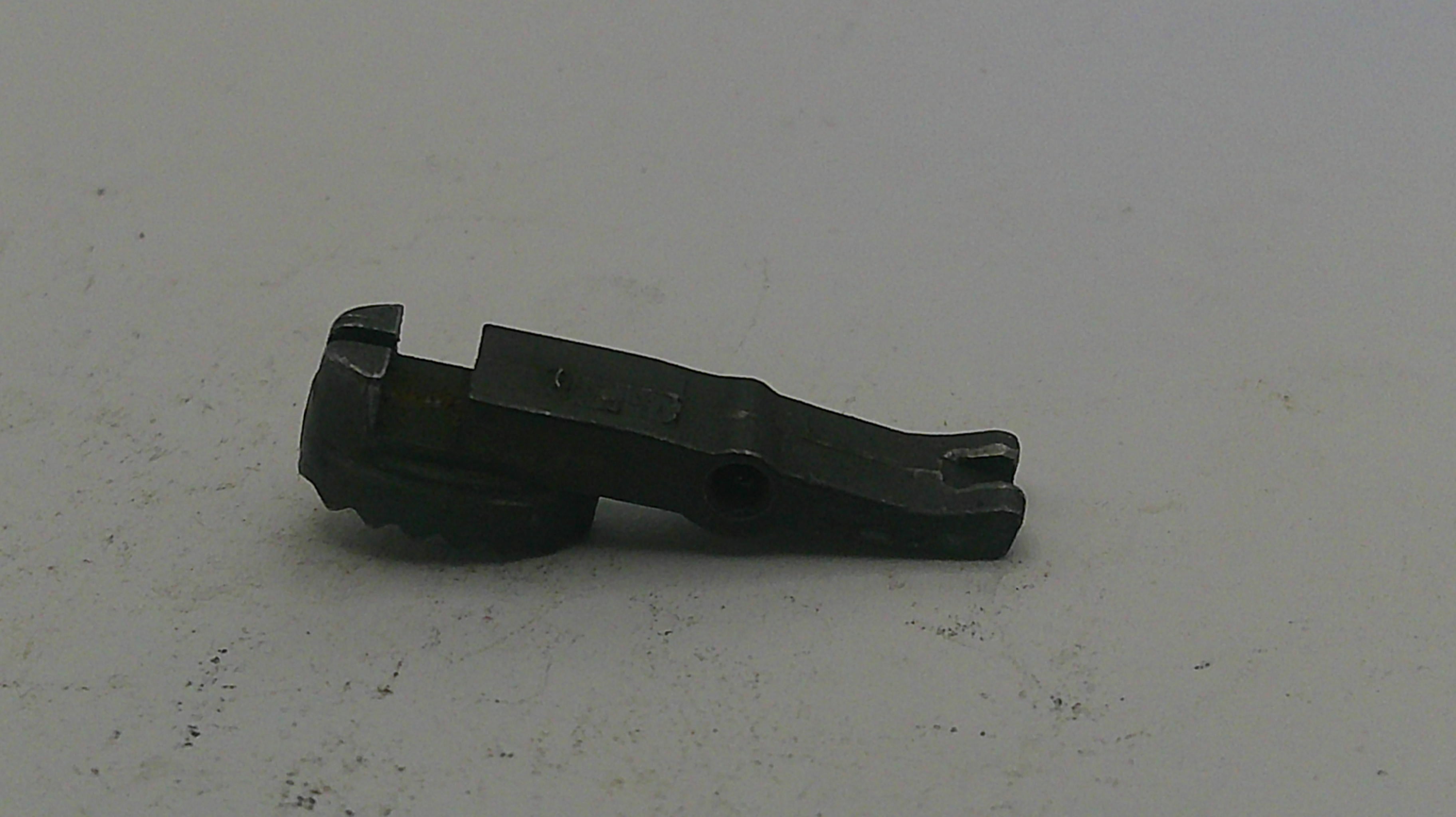 Black metal component on a light gray background