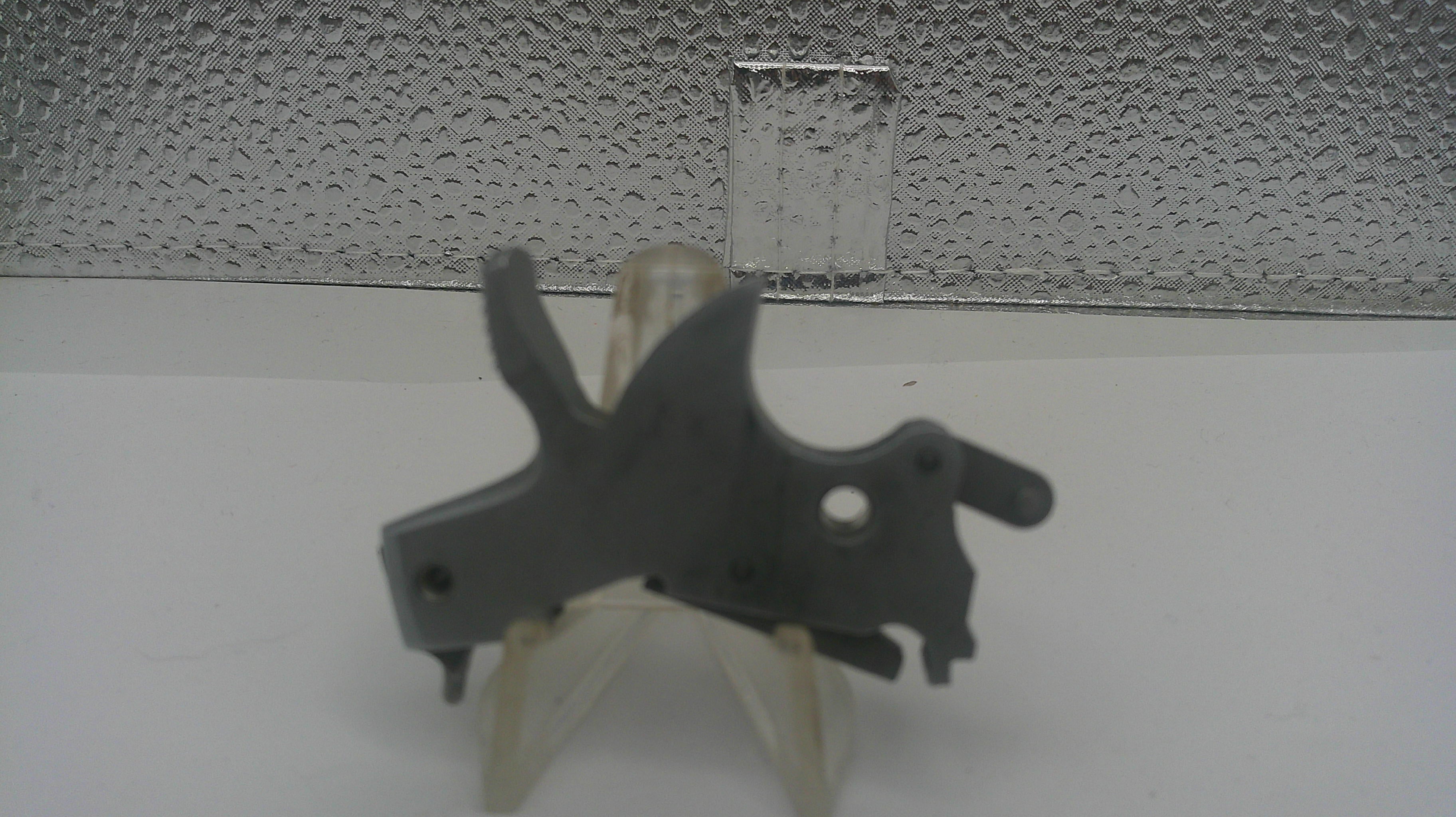 Mechanical component on a stand against a textured wall background