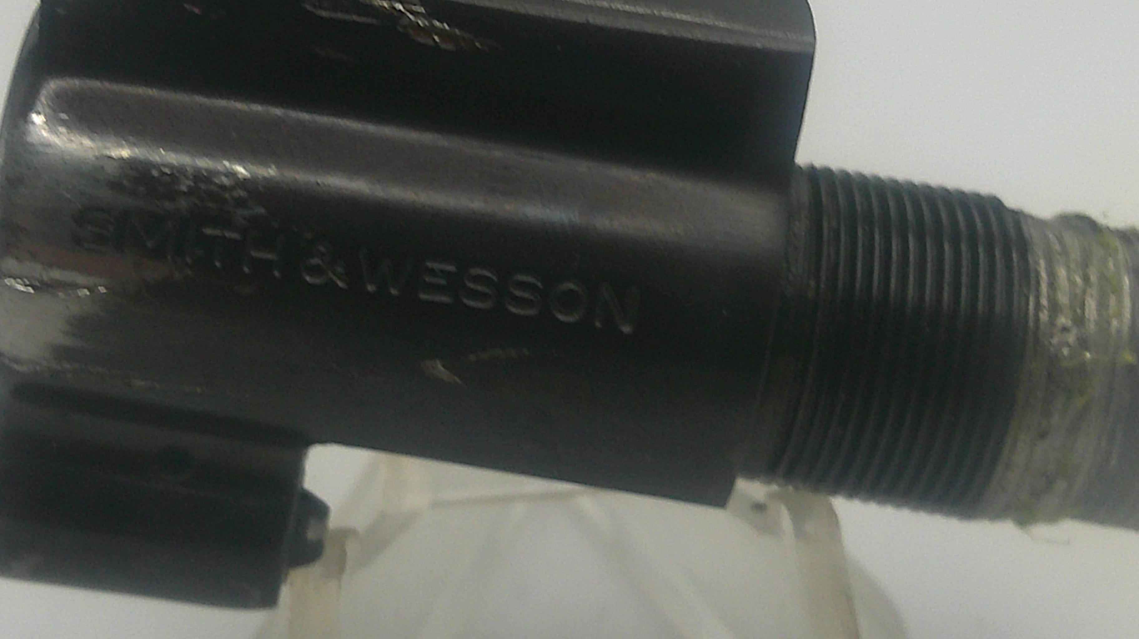 Black firearm barrel with 'Smith & Wesson' engraving on a white background