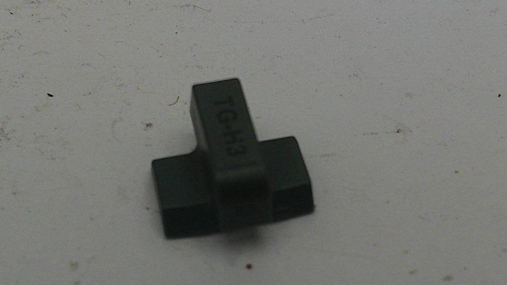 Black plastic component on a white background