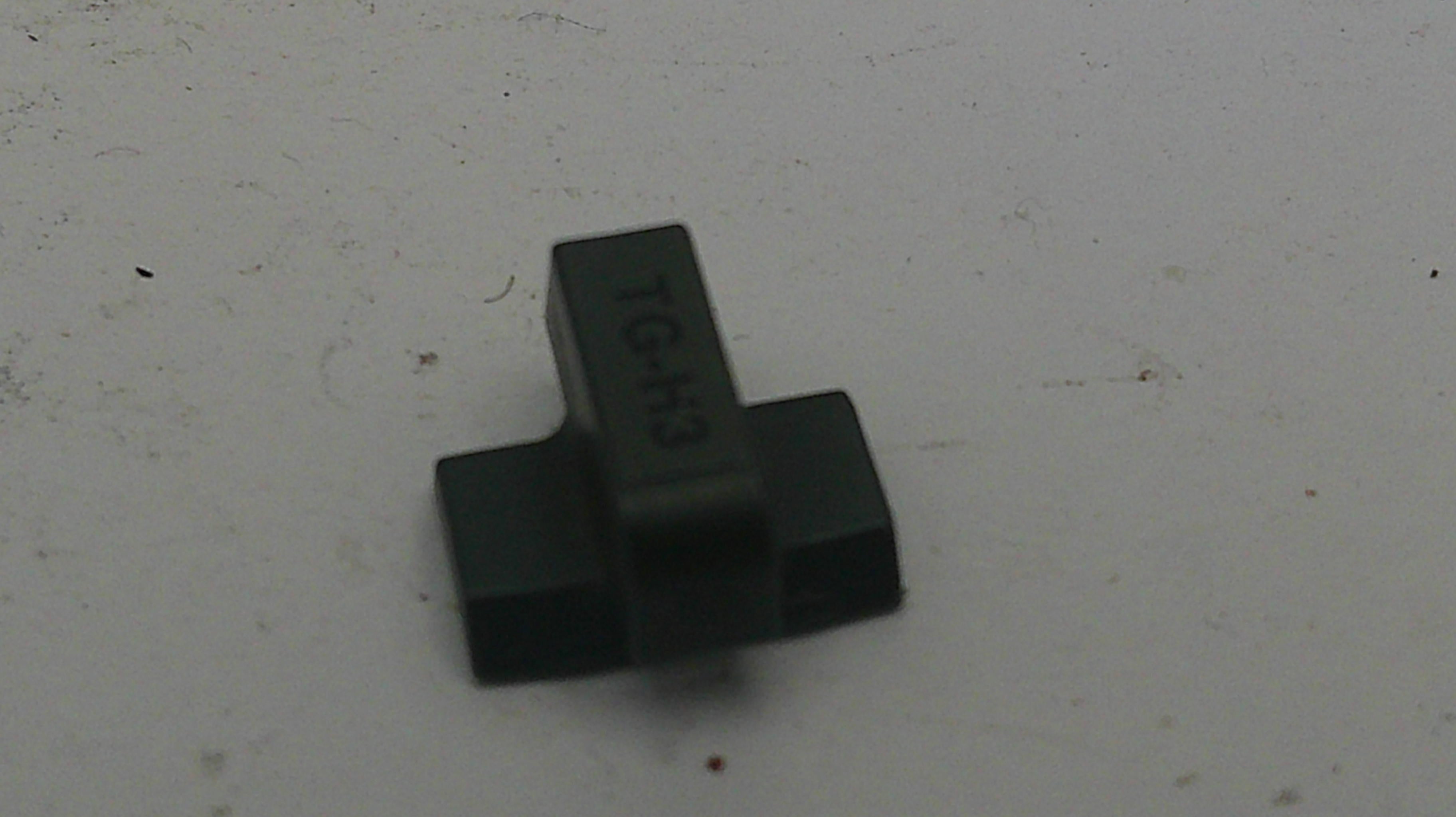Black plastic component on a white background