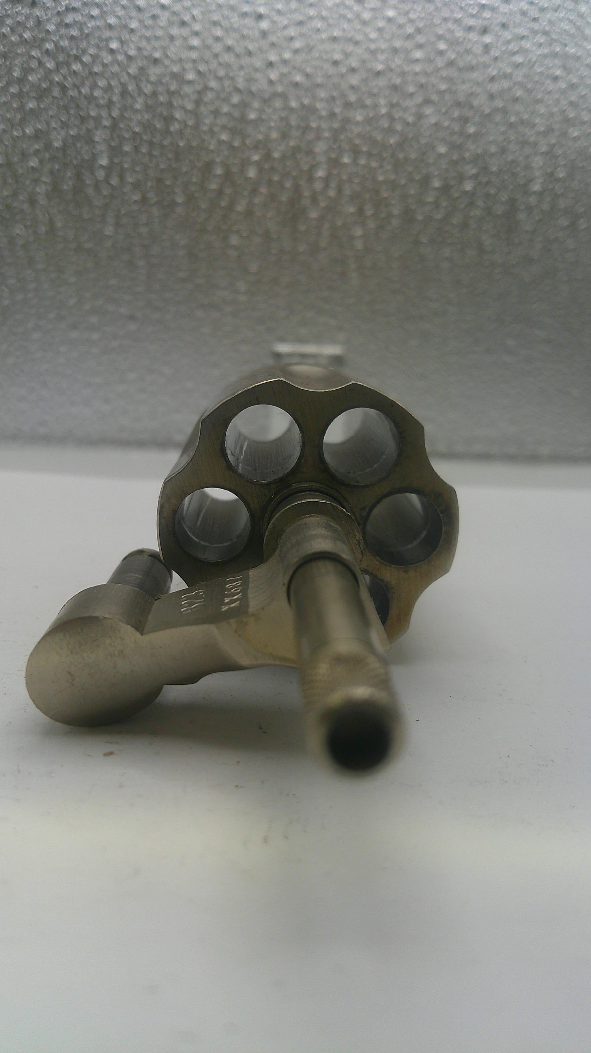Brass valve on a textured wall