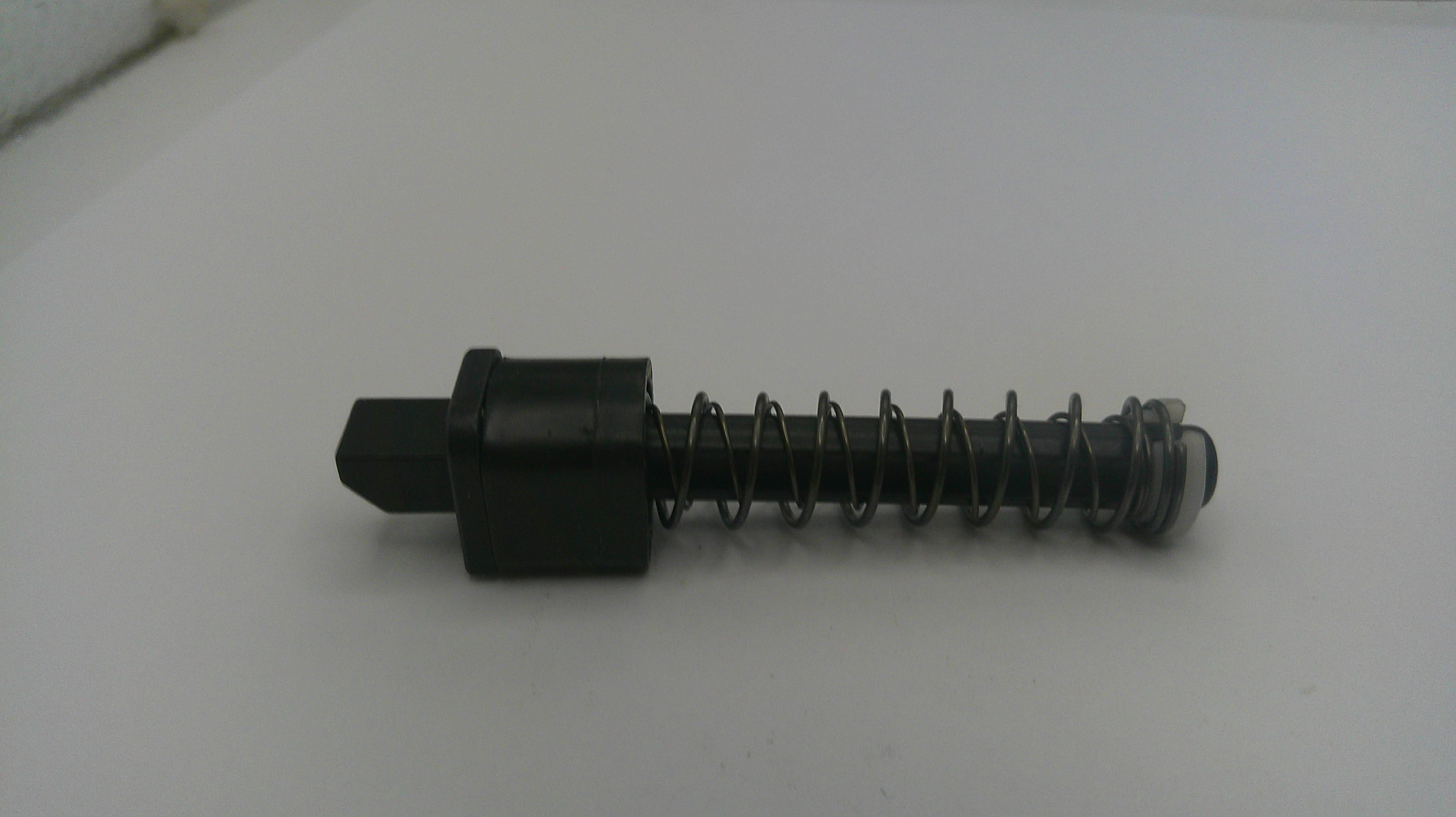 Black mechanical component with spring on a white background