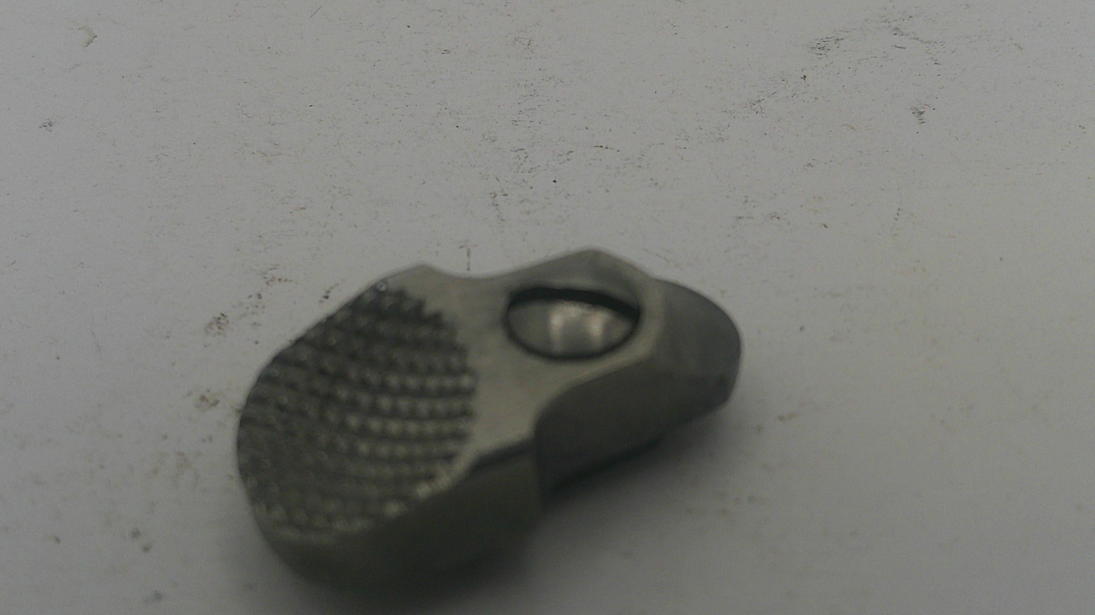 Metallic tool with textured surface on a white background