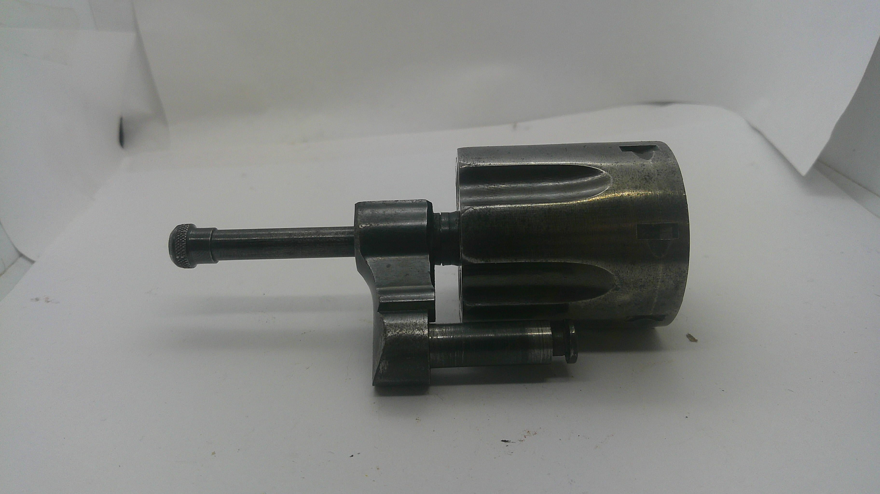 A used dark metallic mechanical part, possibly a tool component or motor assembly, photographed on a white background.