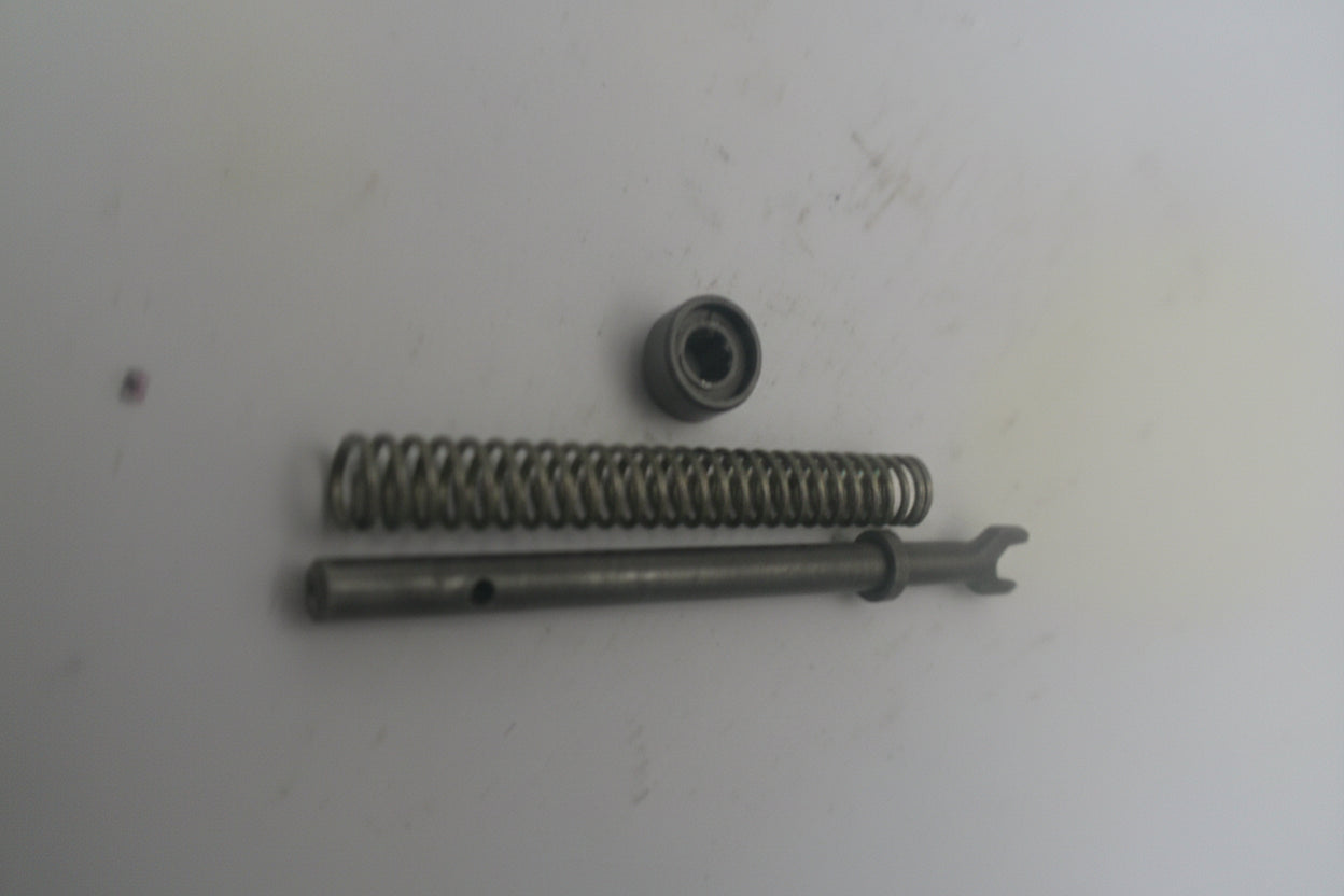 Metal spring and metal ball on a white surface