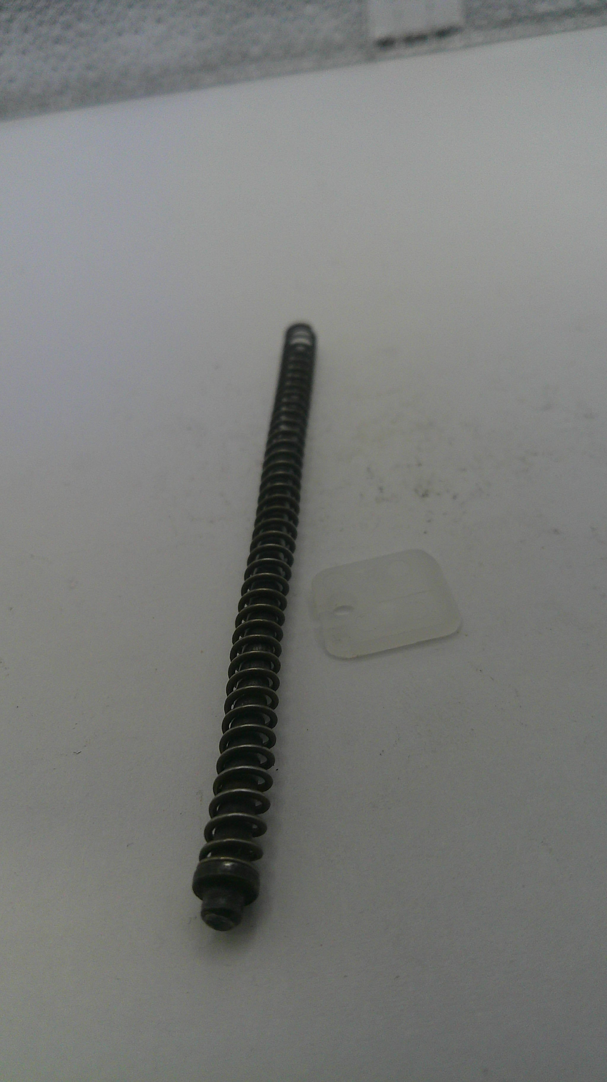 Long black screw on a white surface