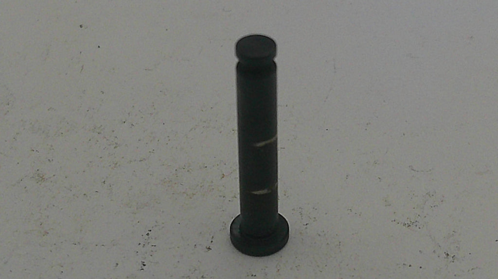 Black cylindrical object on a light gray background