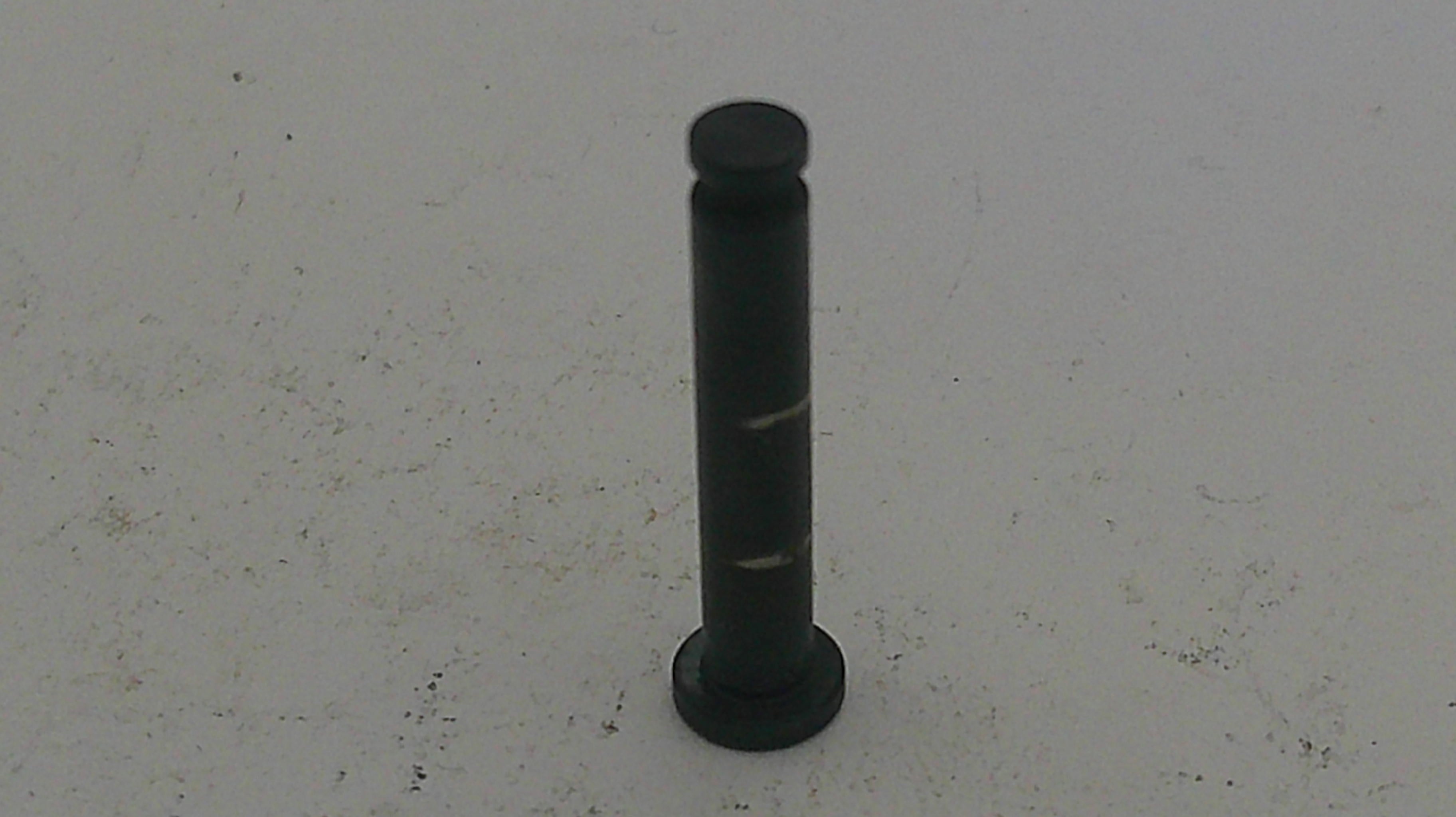 Black cylindrical object on a light gray background
