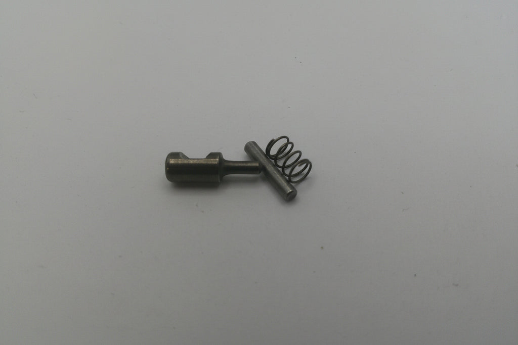 Small metal spring and pin on a white background