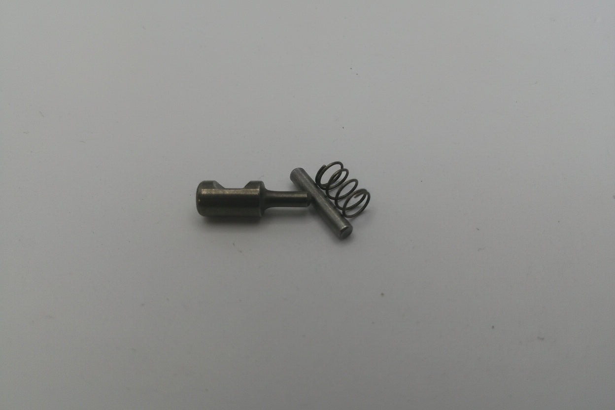 Small metal spring and pin on a white background