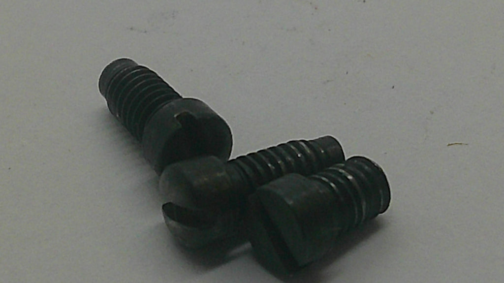 Three black slotted wood screws with threaded shanks, arranged on a plain light gray surface.