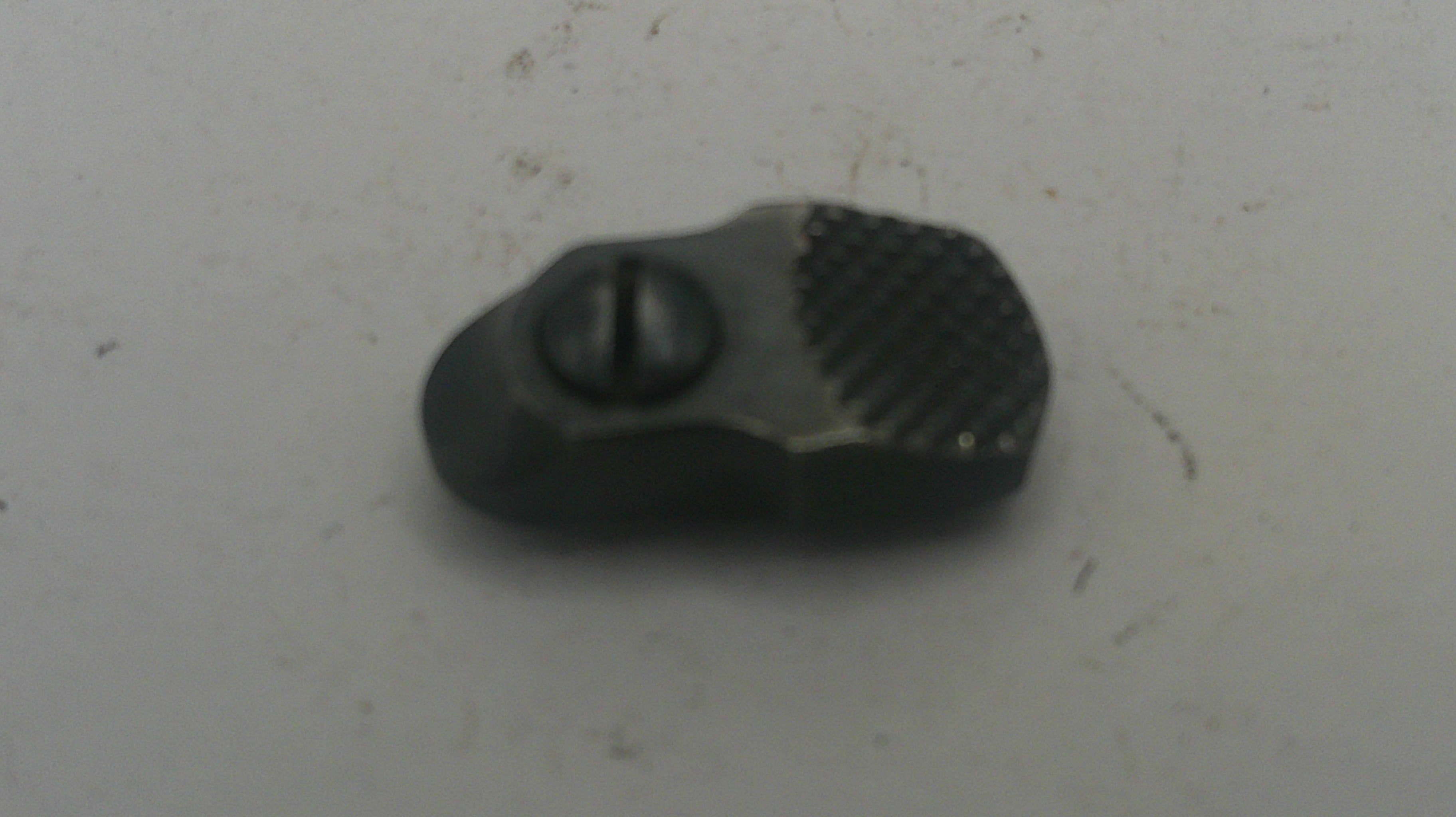 Black plastic component on a light gray background