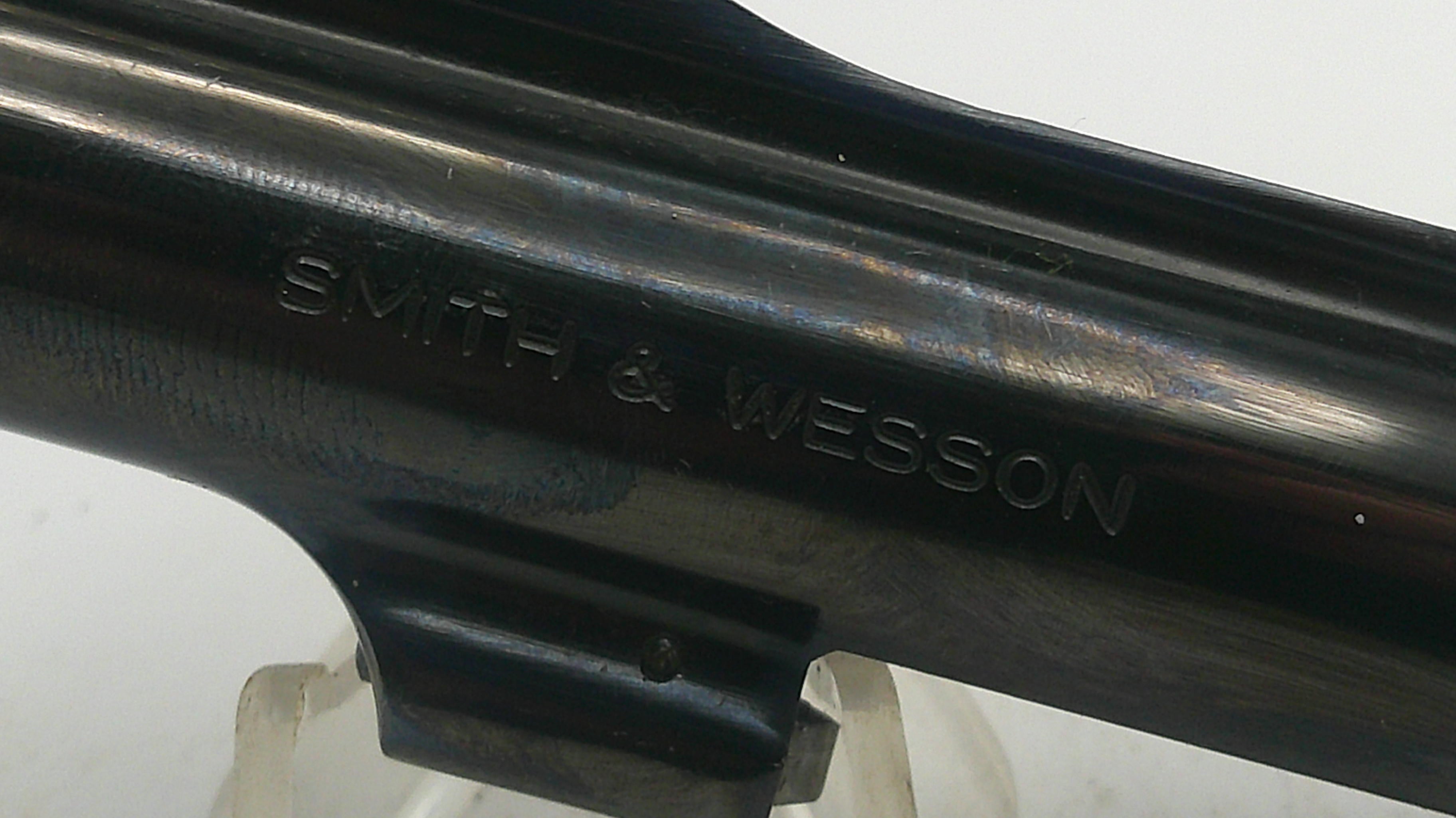 Close-up of a Smith & Wesson firearm barrel on a white background