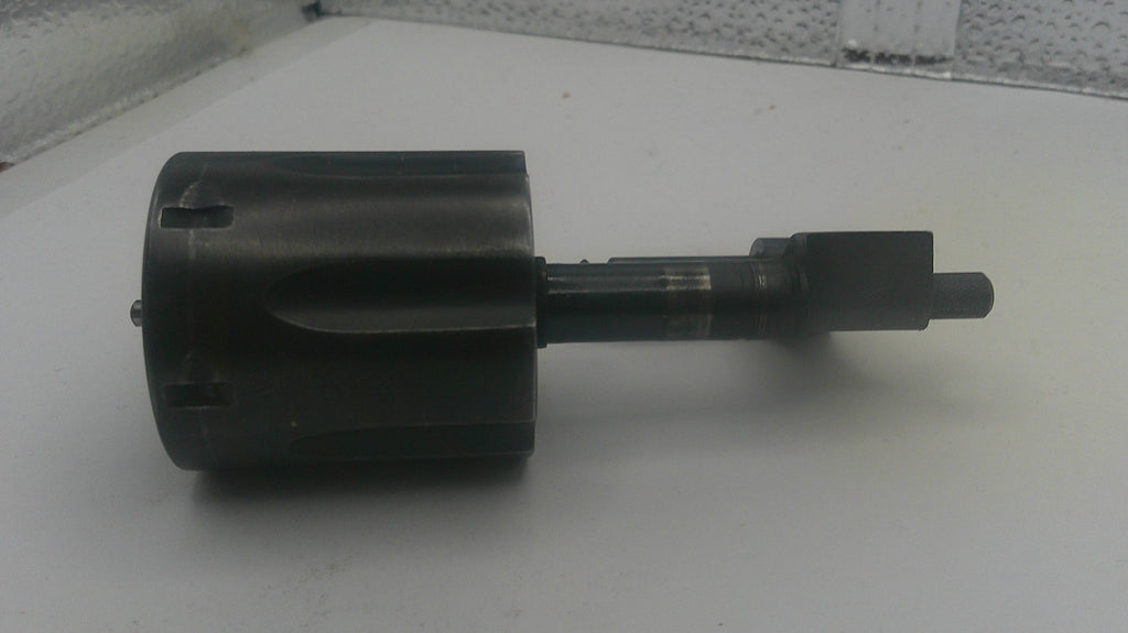Black mechanical component on a white surface