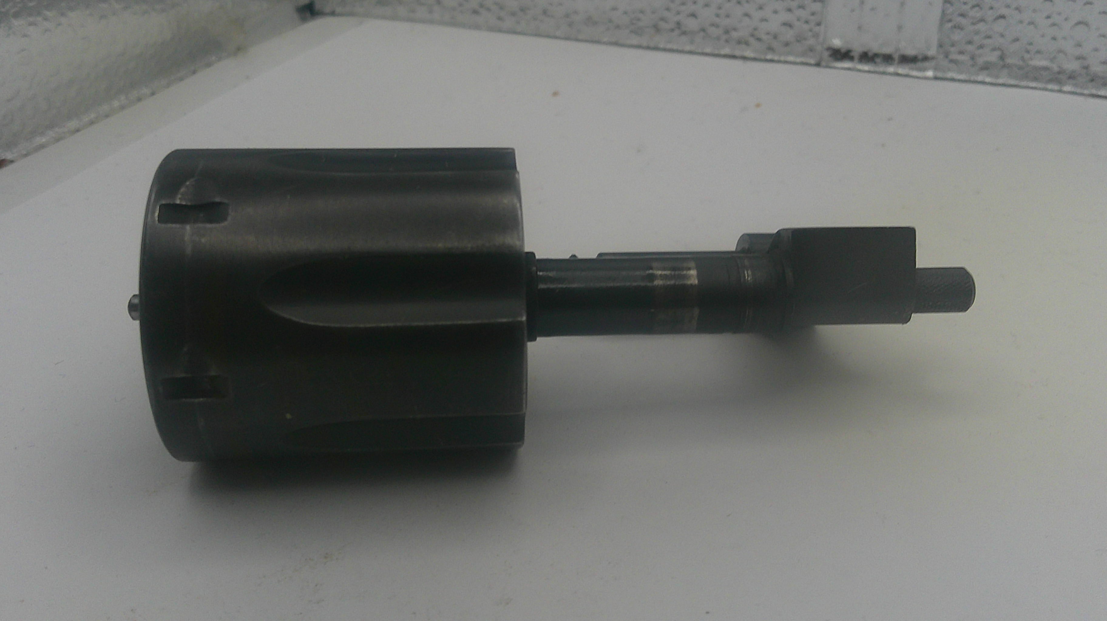 Black mechanical component on a white surface
