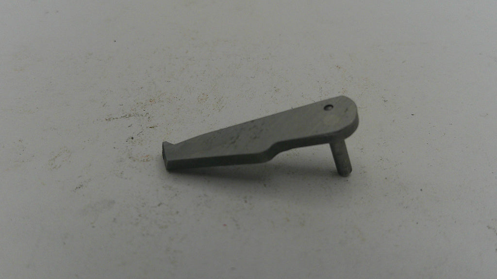Metallic object on a textured white surface