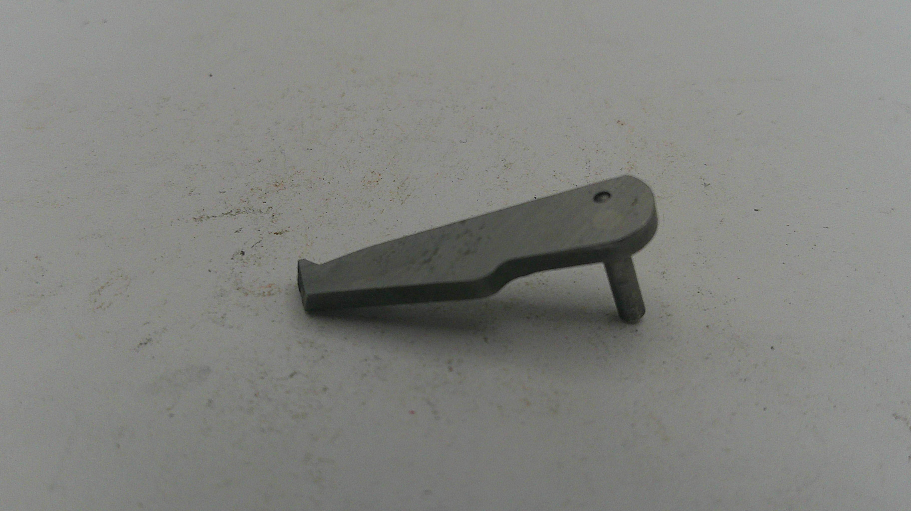 Metallic object on a textured white surface