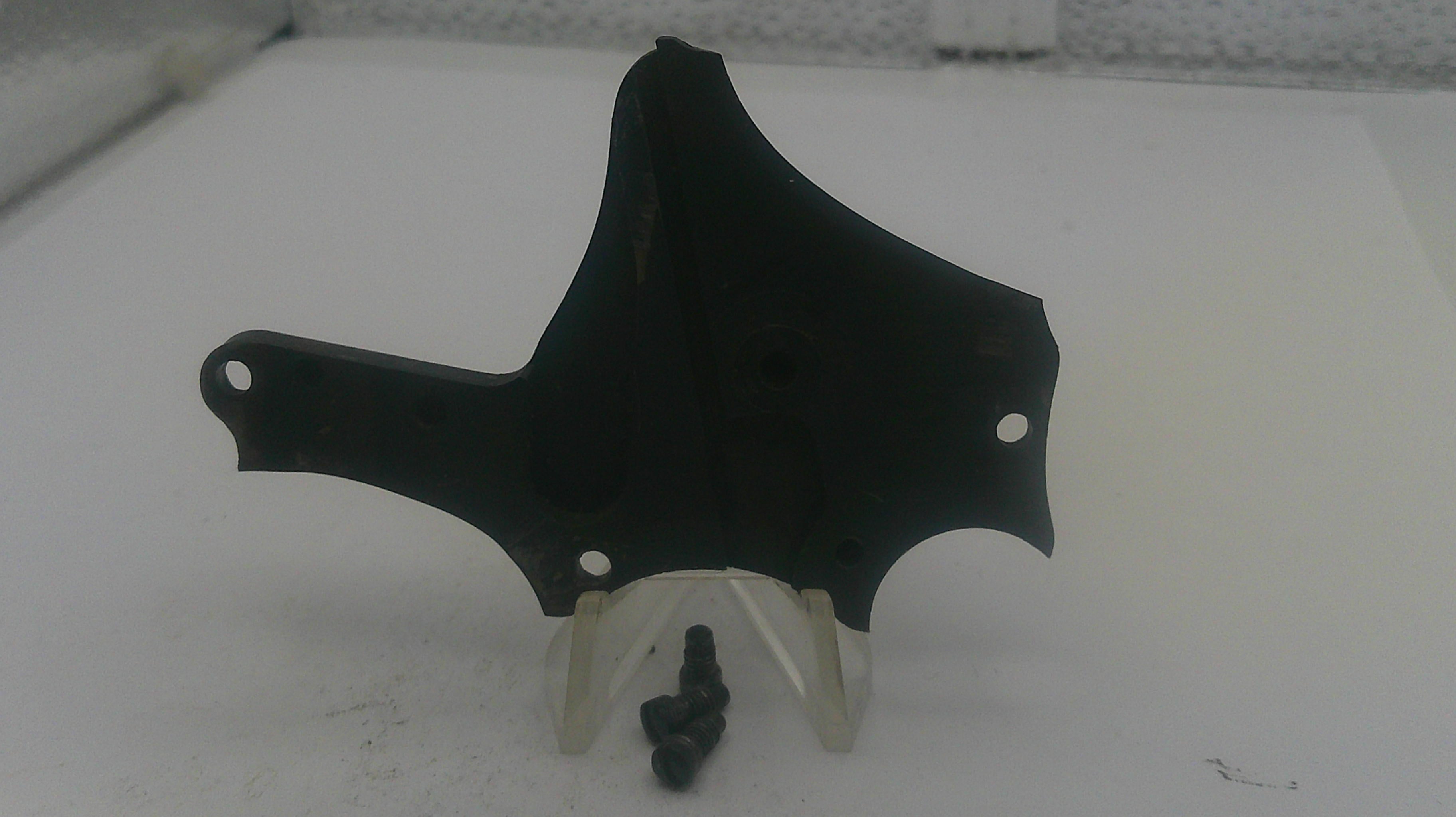 Black motorcycle fairing on a white stand with a white background