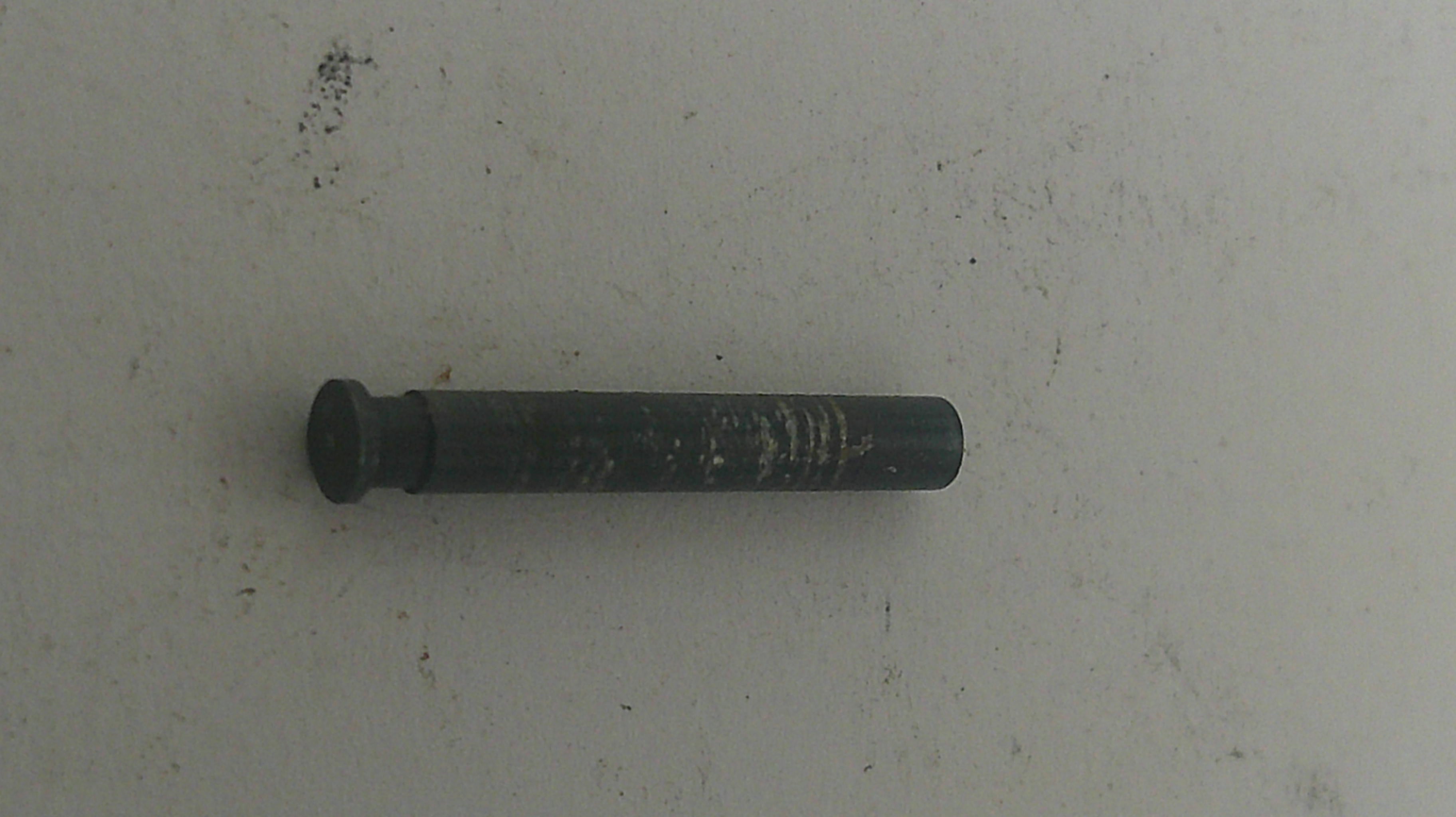 Black metal bolt on a light gray background