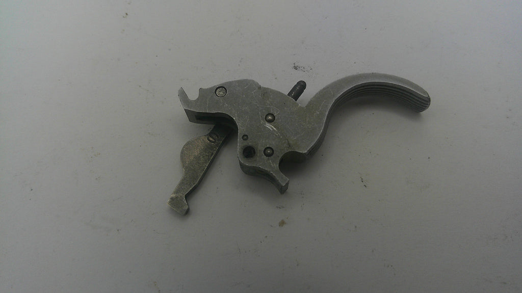 Metallic gun trigger on a white background