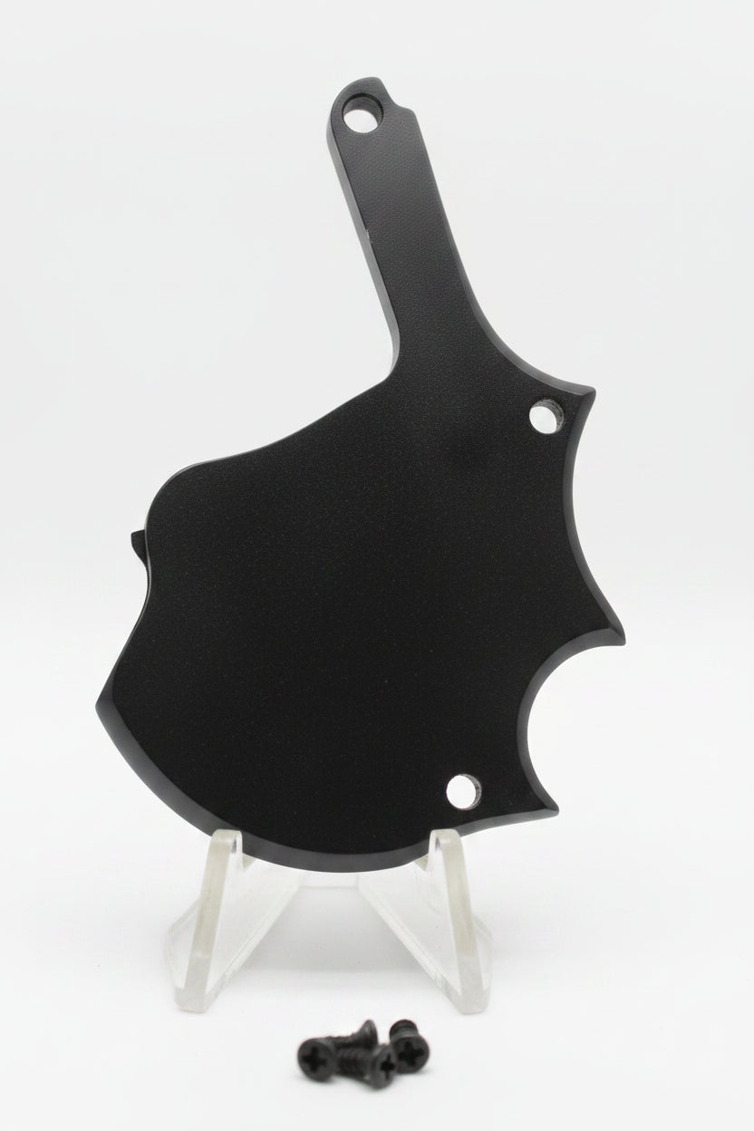 Black butterfly-shaped object on a textured white background