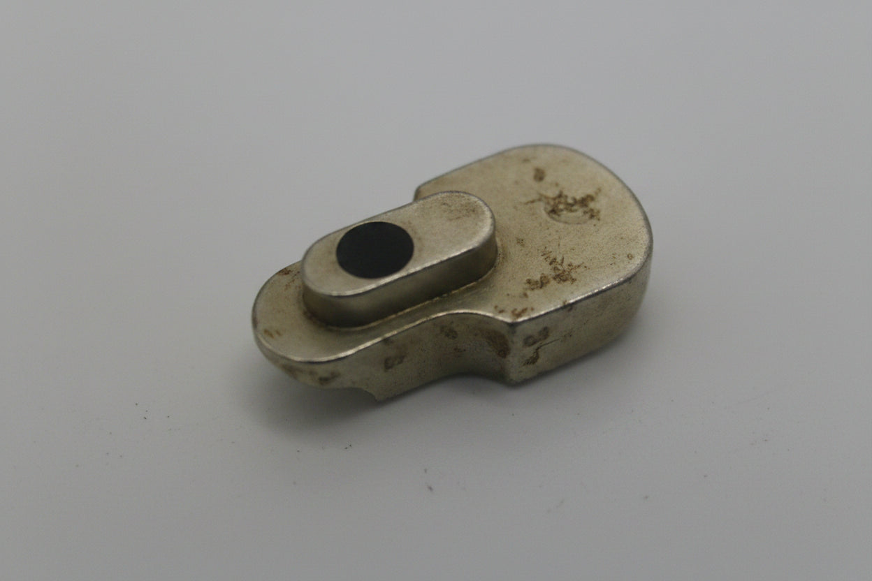 Small ceramic or stone object on a plain background