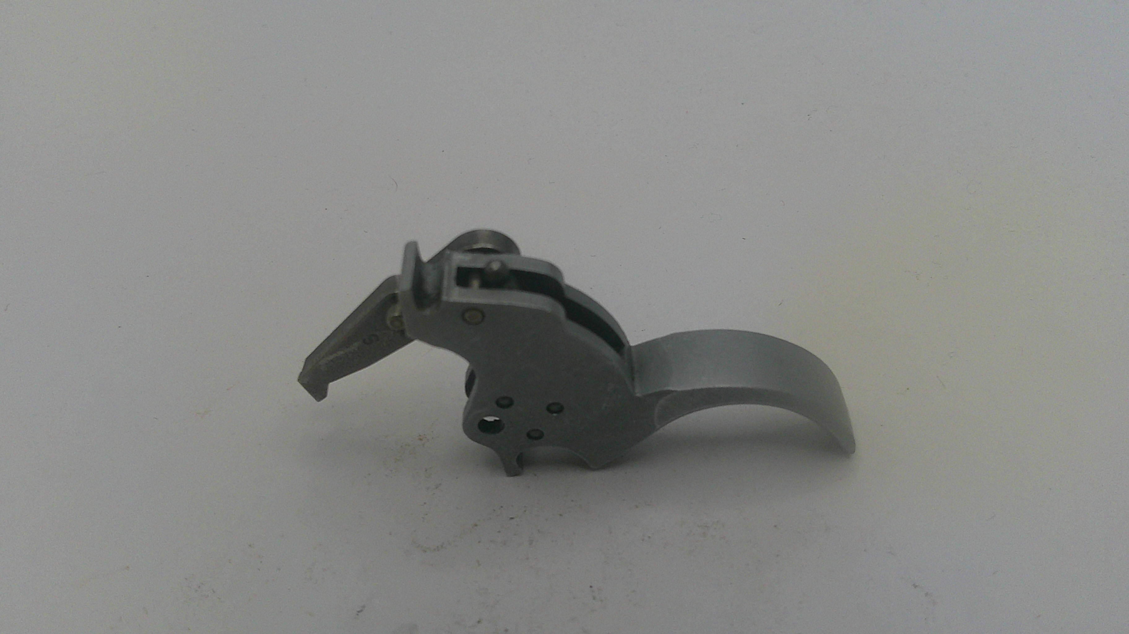 Metallic gun trigger on a white background