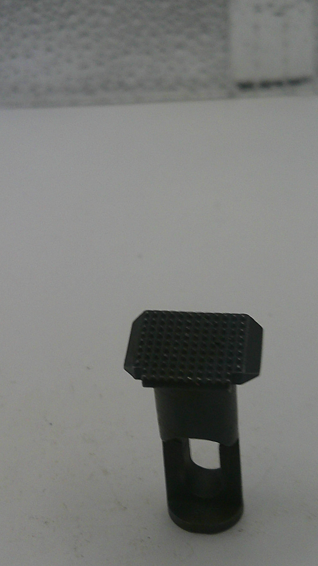 Black textured object on a white background