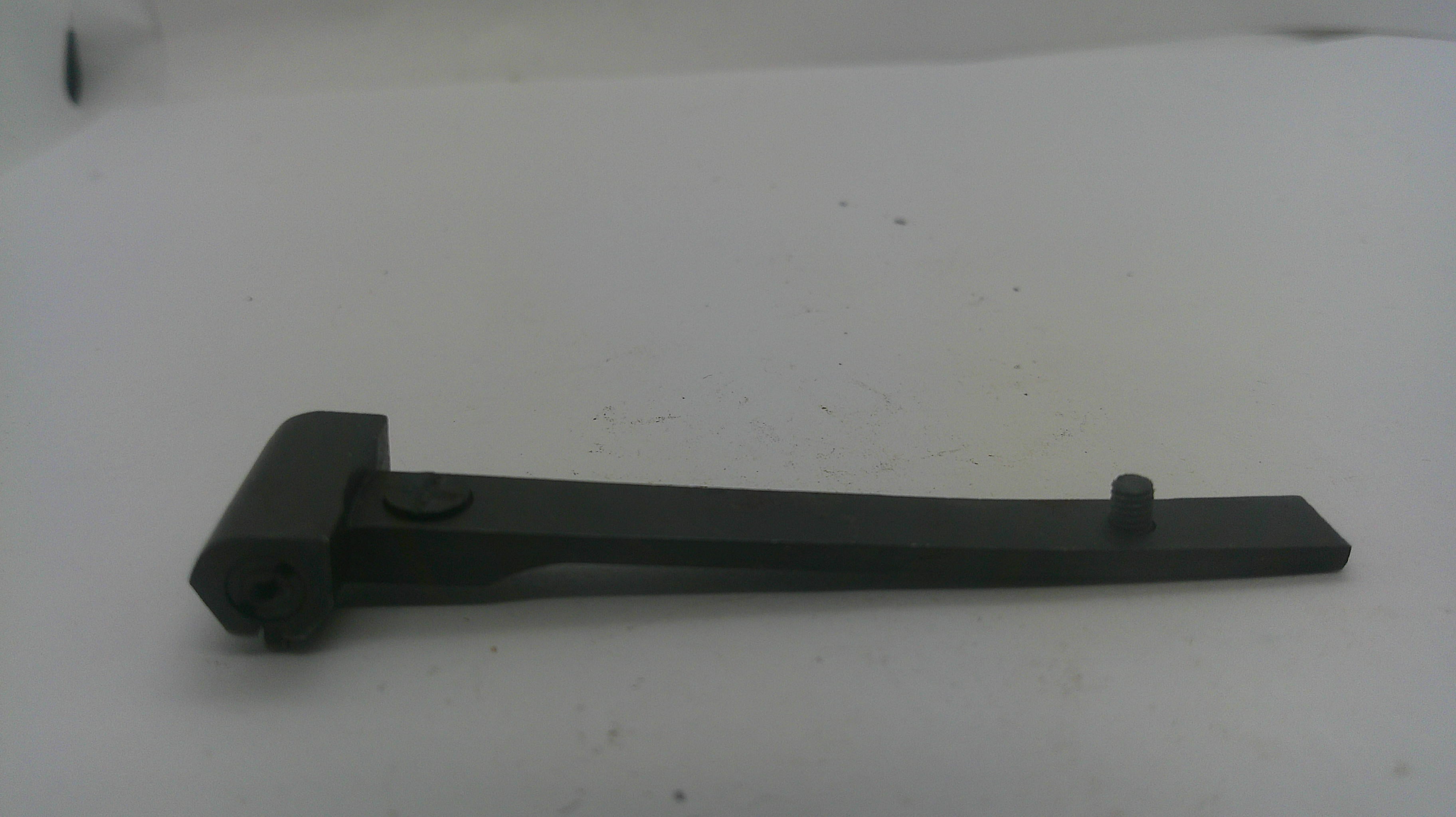 A black metal lever or bracket with a flat arm and a small cylindrical protrusion, photographed on a plain light background.