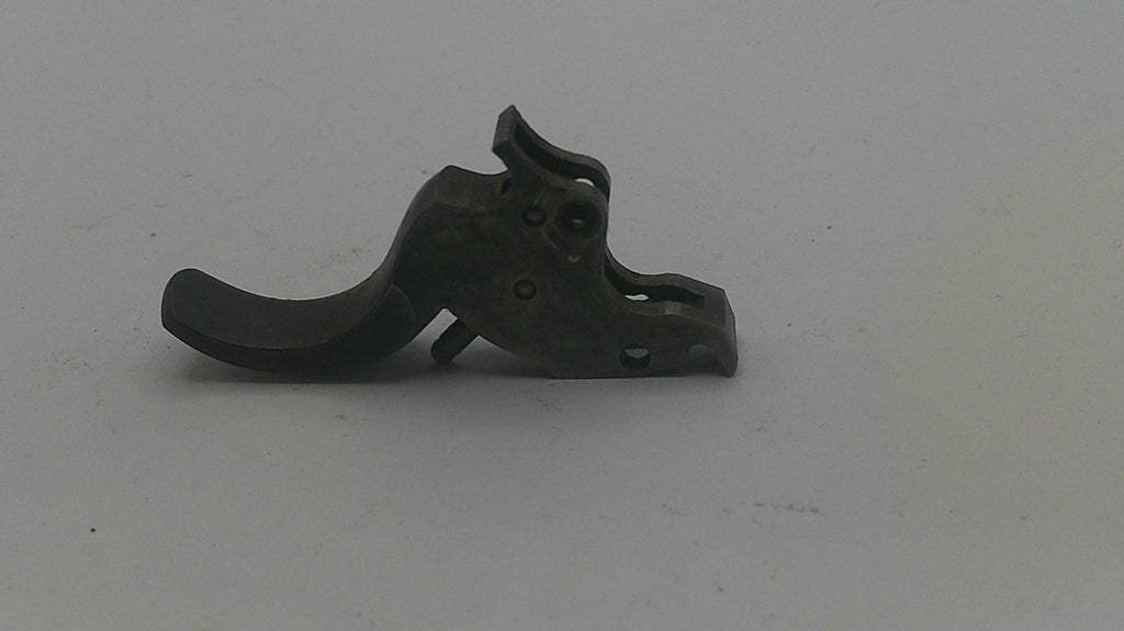 Metallic gun trigger on a white background