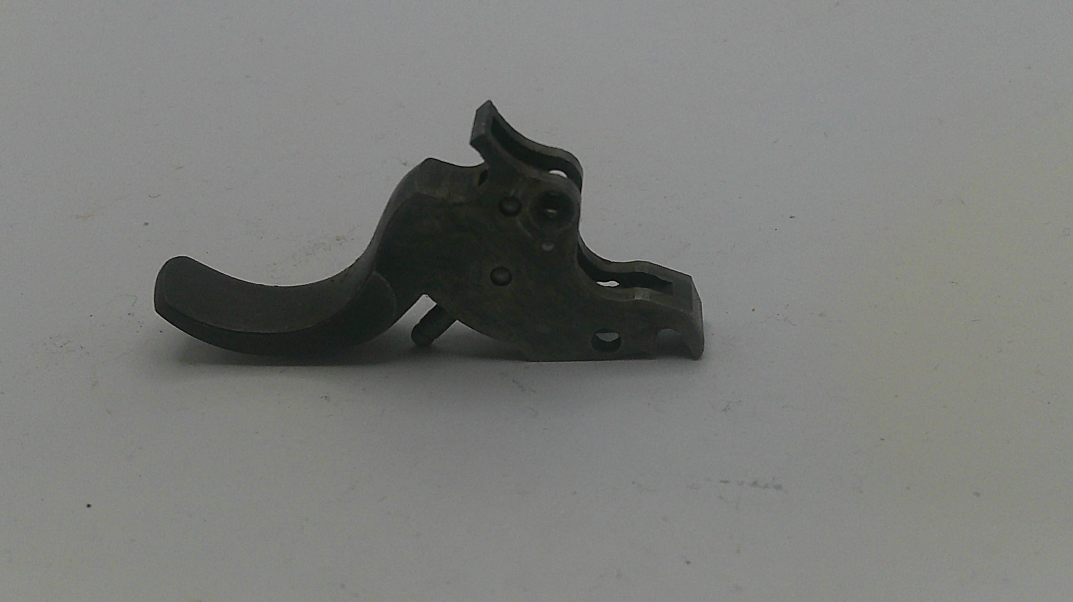 Metallic gun trigger on a white background