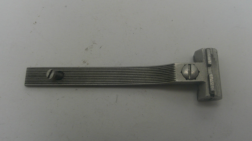 Metallic tool with a textured handle on a gray background