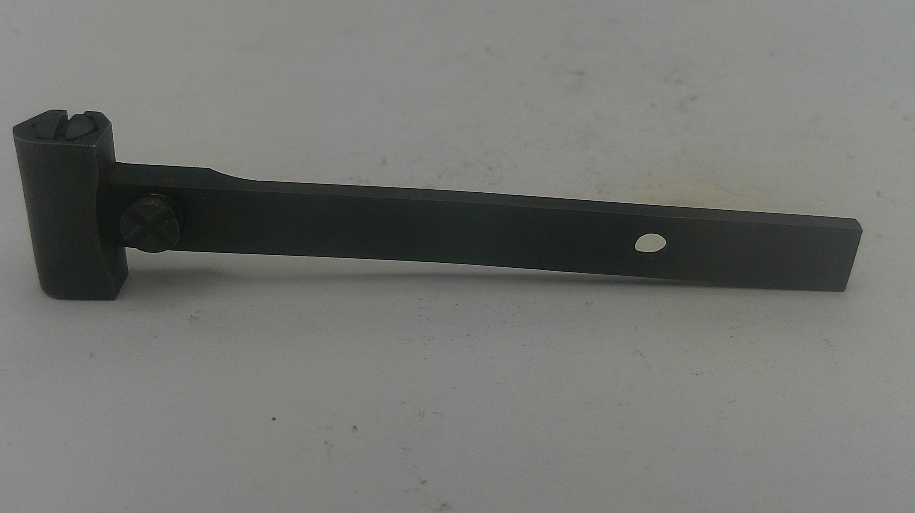 A black metal hardware bracket or latch piece with a rectangular base, a short stem, and a circular hole near the end, photographed on a plain light background.