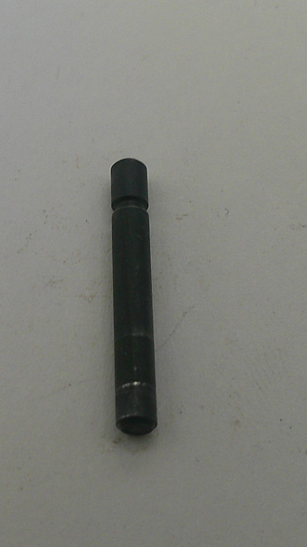 Black cylindrical object on a white background