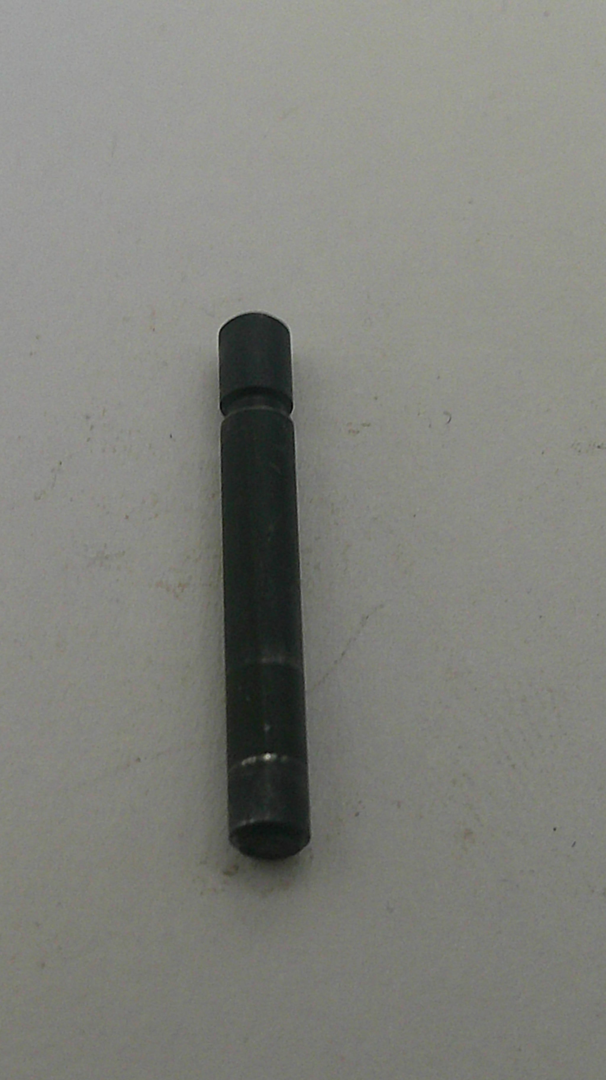 Black cylindrical object on a white background