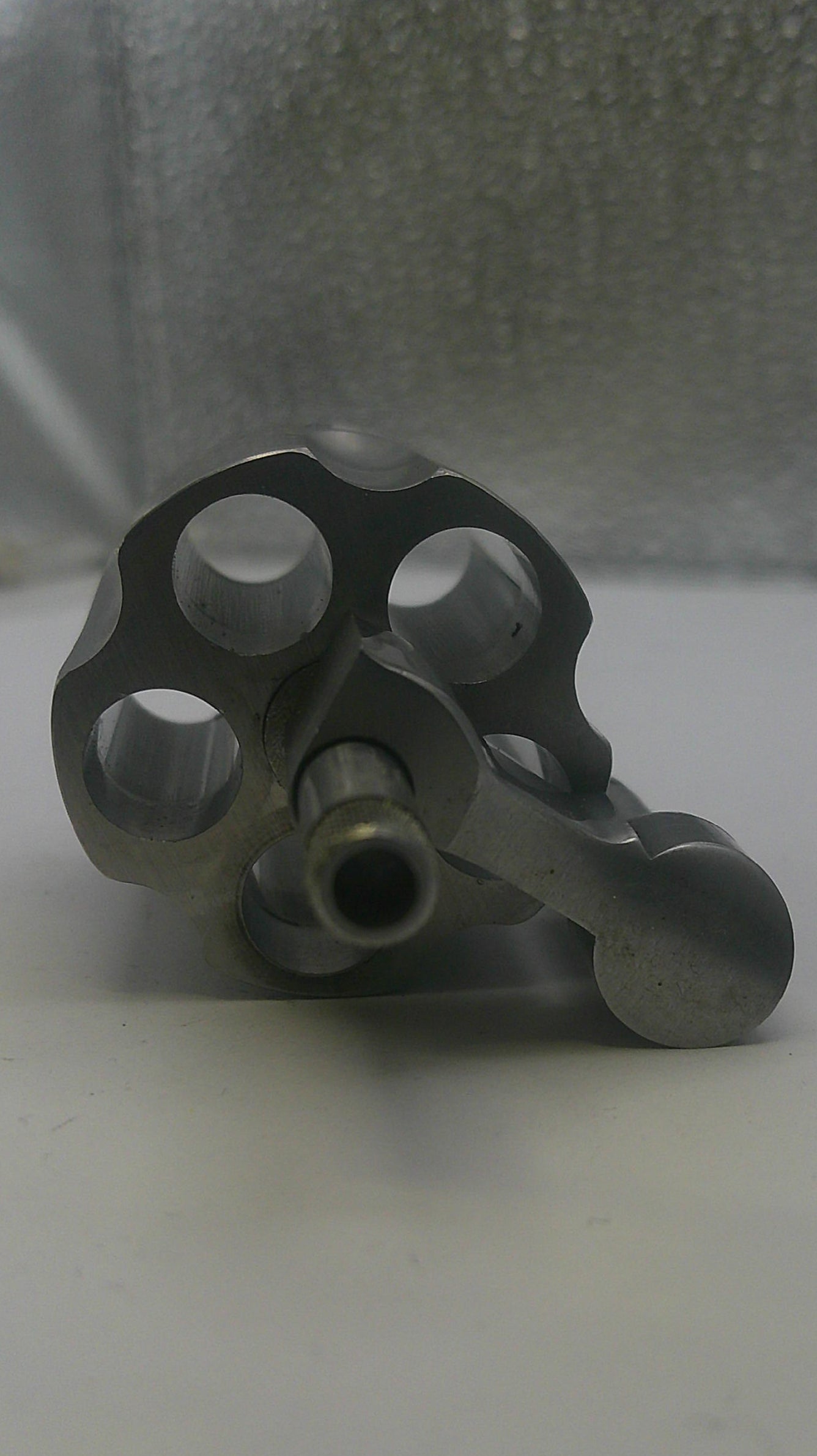 Metal valve handle on a white surface