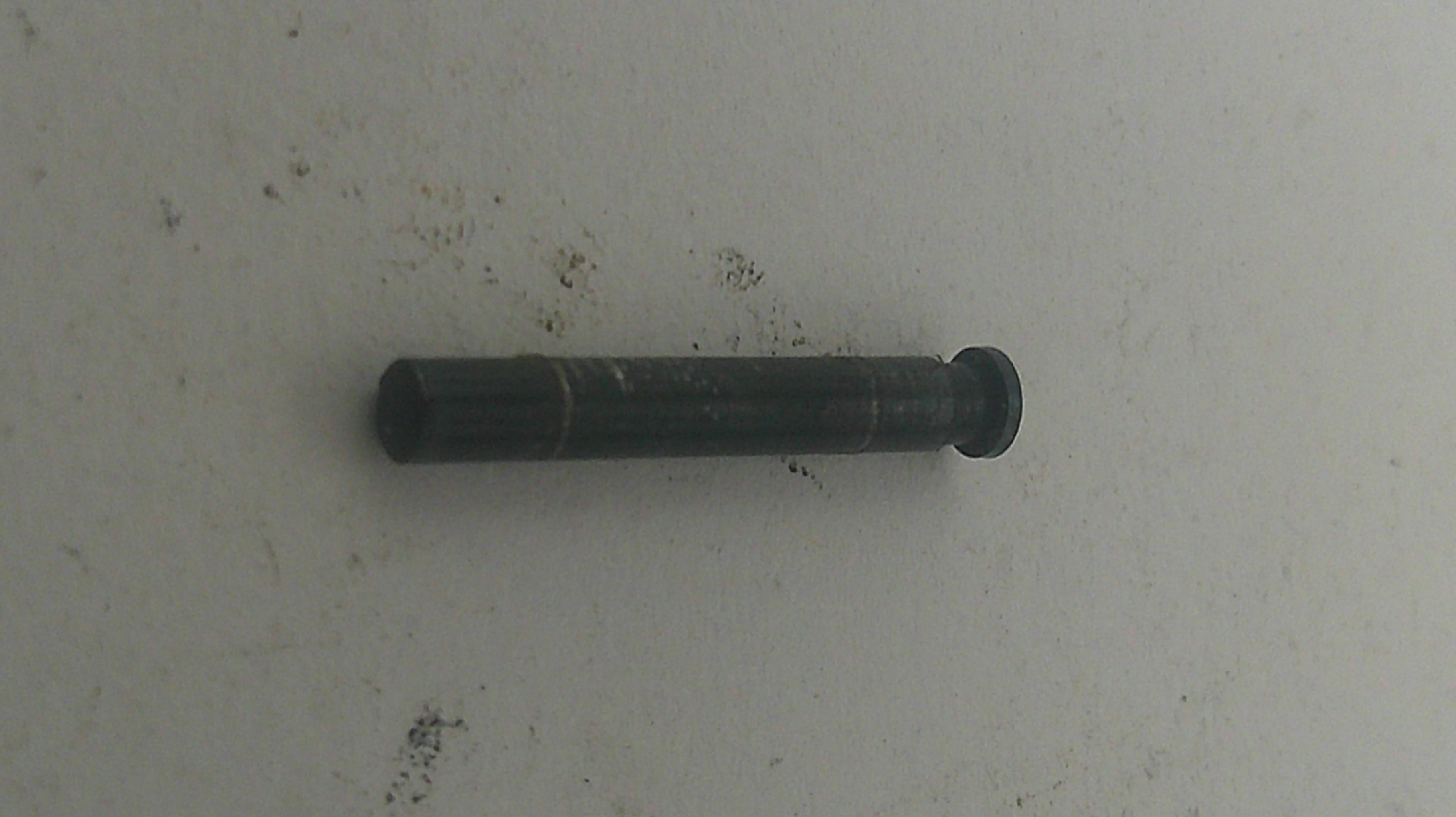 Black cylindrical object on a light gray background