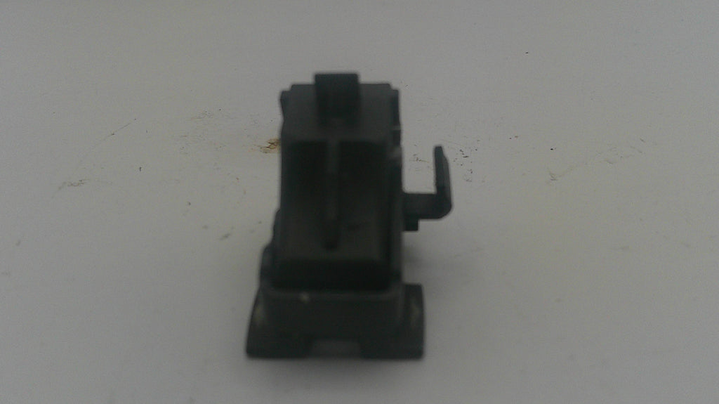 A small black plastic mechanical component or switch with a vertical body and a small side tab, photographed on a plain light background.