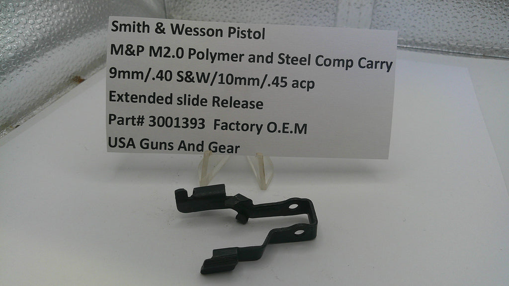 Black gun slide component with a label on a white surface