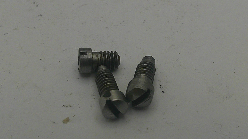 Three metal screws on a light gray background