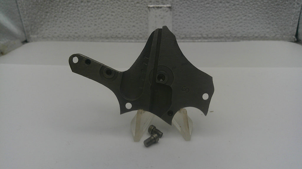 Black metal bracket with screws on a white surface