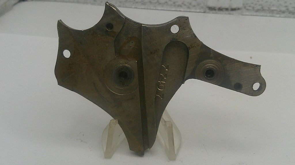 Pair of metal brackets on a white stand with a white background