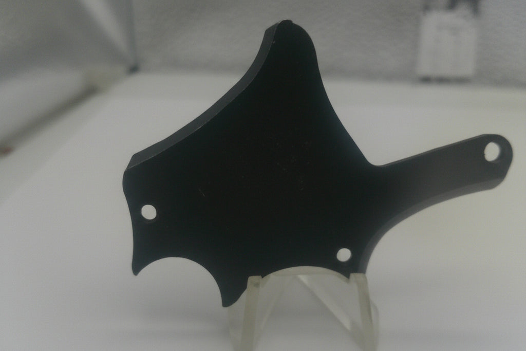 Black plastic component on a white background