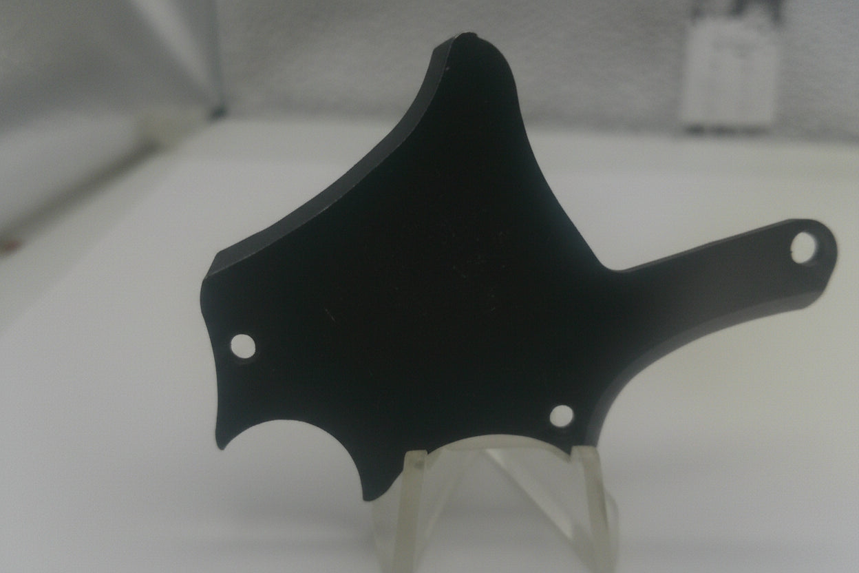 Black plastic component on a white background