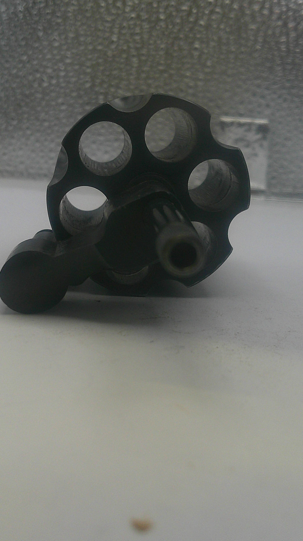 Black metal knuckle duster on a textured surface