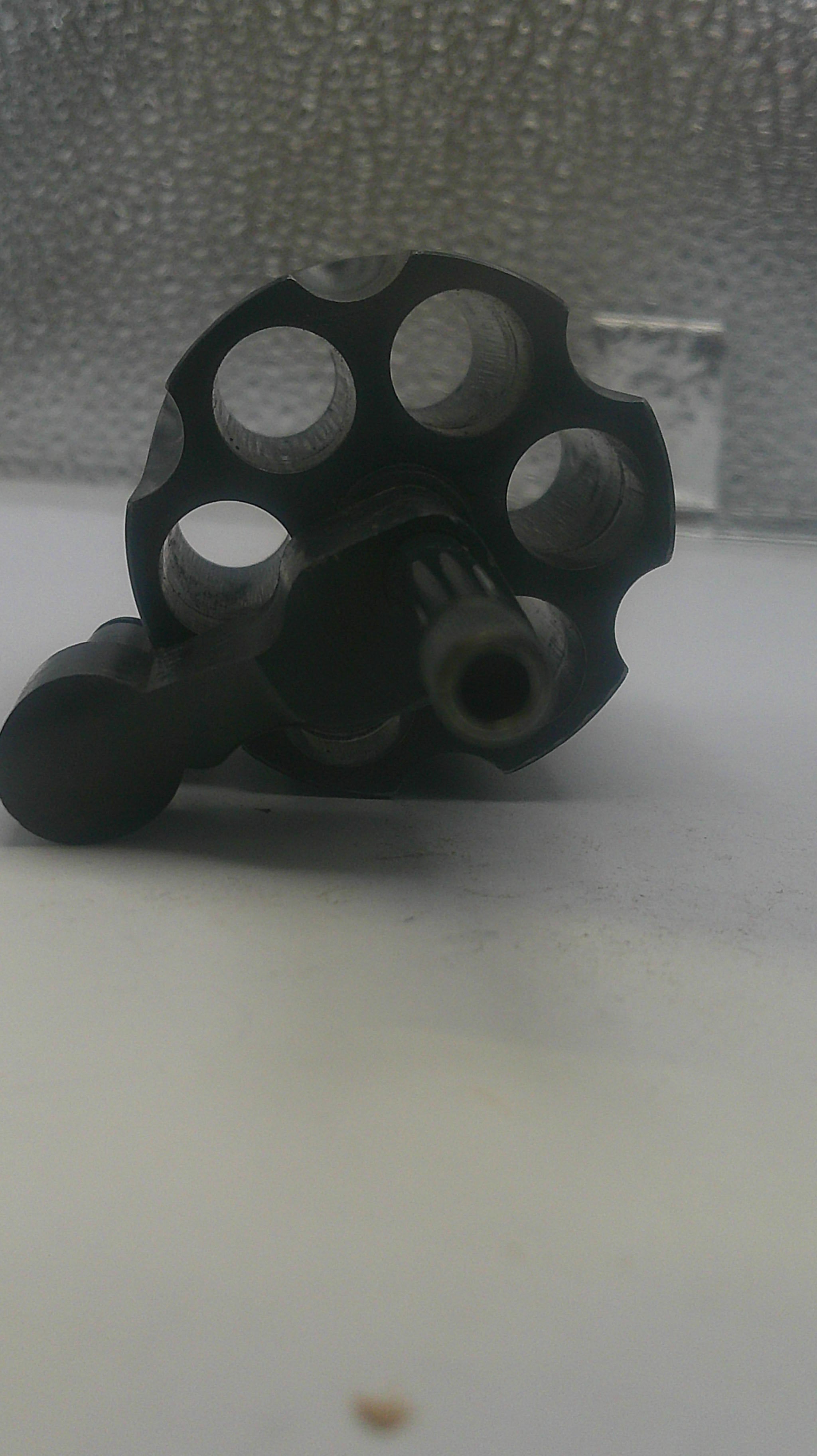 Black metal knuckle duster on a textured surface