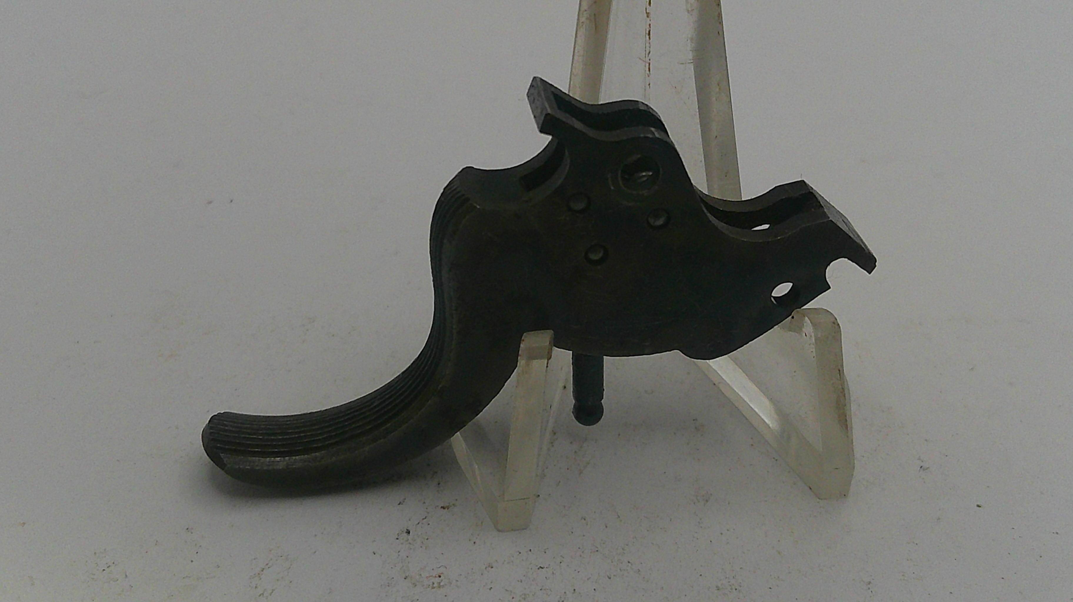 Black metal lever on a white stand against a white background