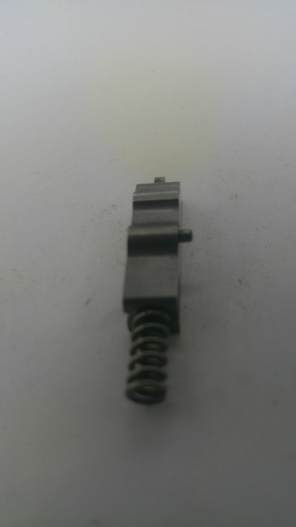 Metal spring and component on a white background